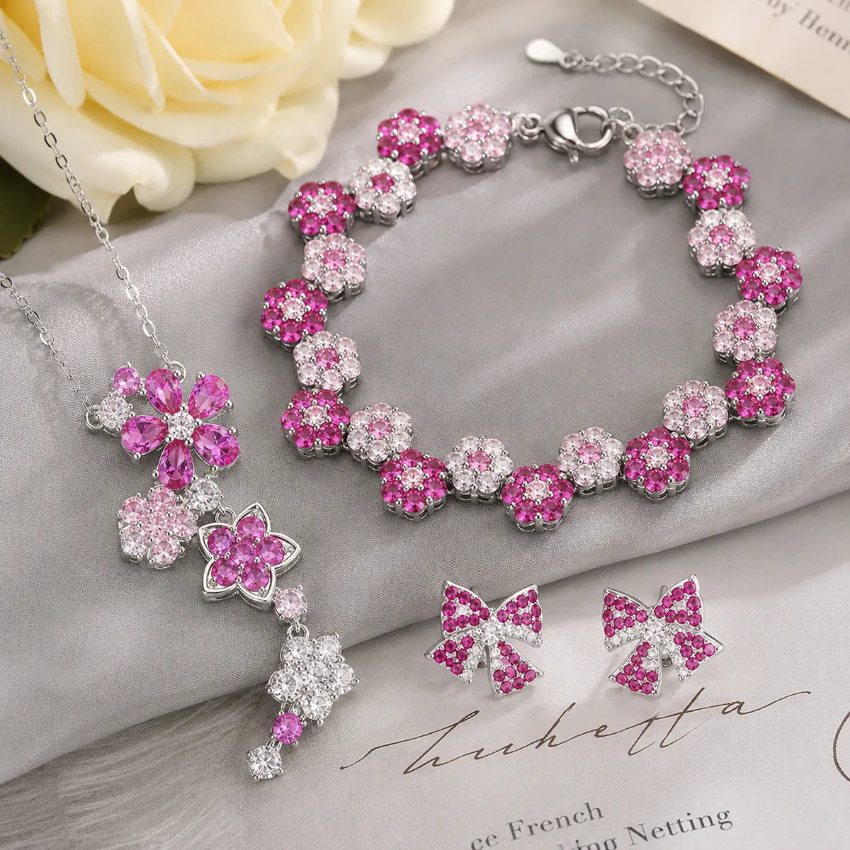 Parure de bijoux romantique avec collier, bracelet et boucles d'oreilles fleuris roses