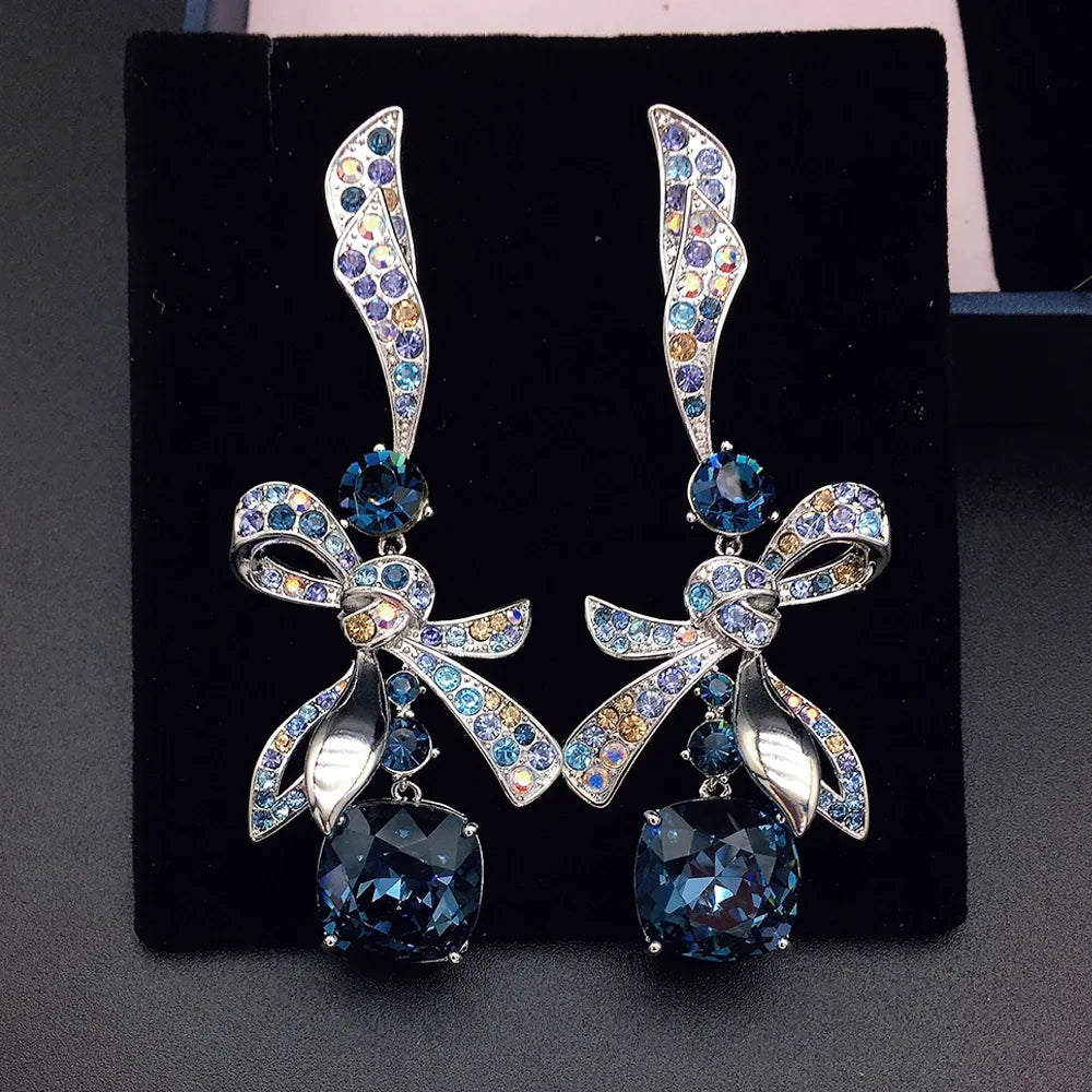 Élégantes boucles d'oreilles pendantes nœud en cristal bleu marine pour femme
