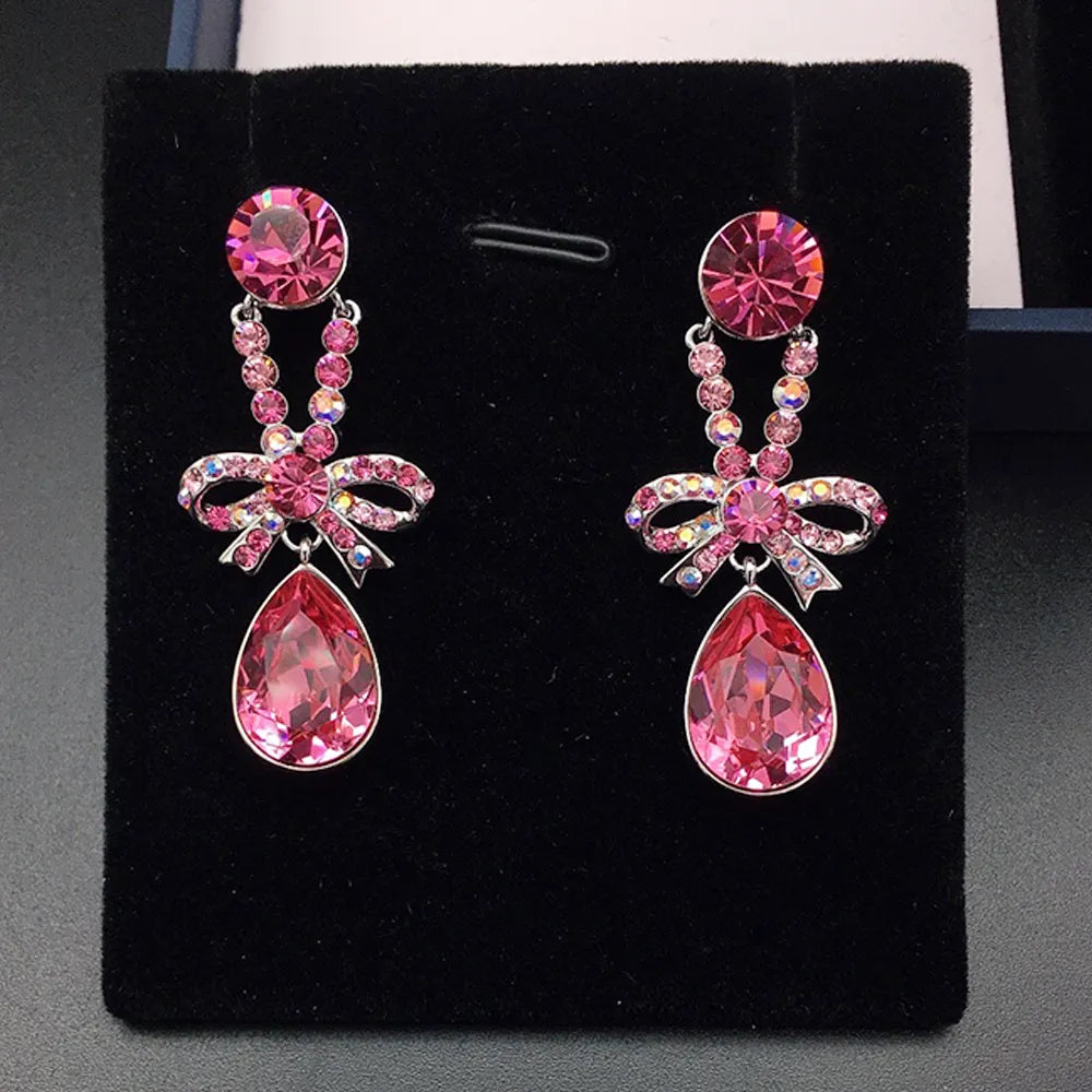 Boucles d'oreilles pendantes élégantes avec nœud en cristal violet pour femmes