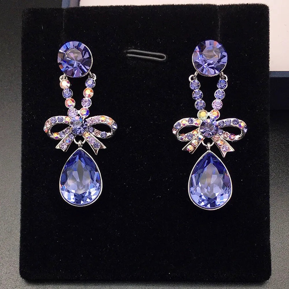 Boucles d'oreilles pendantes élégantes avec nœud en cristal violet pour femmes
