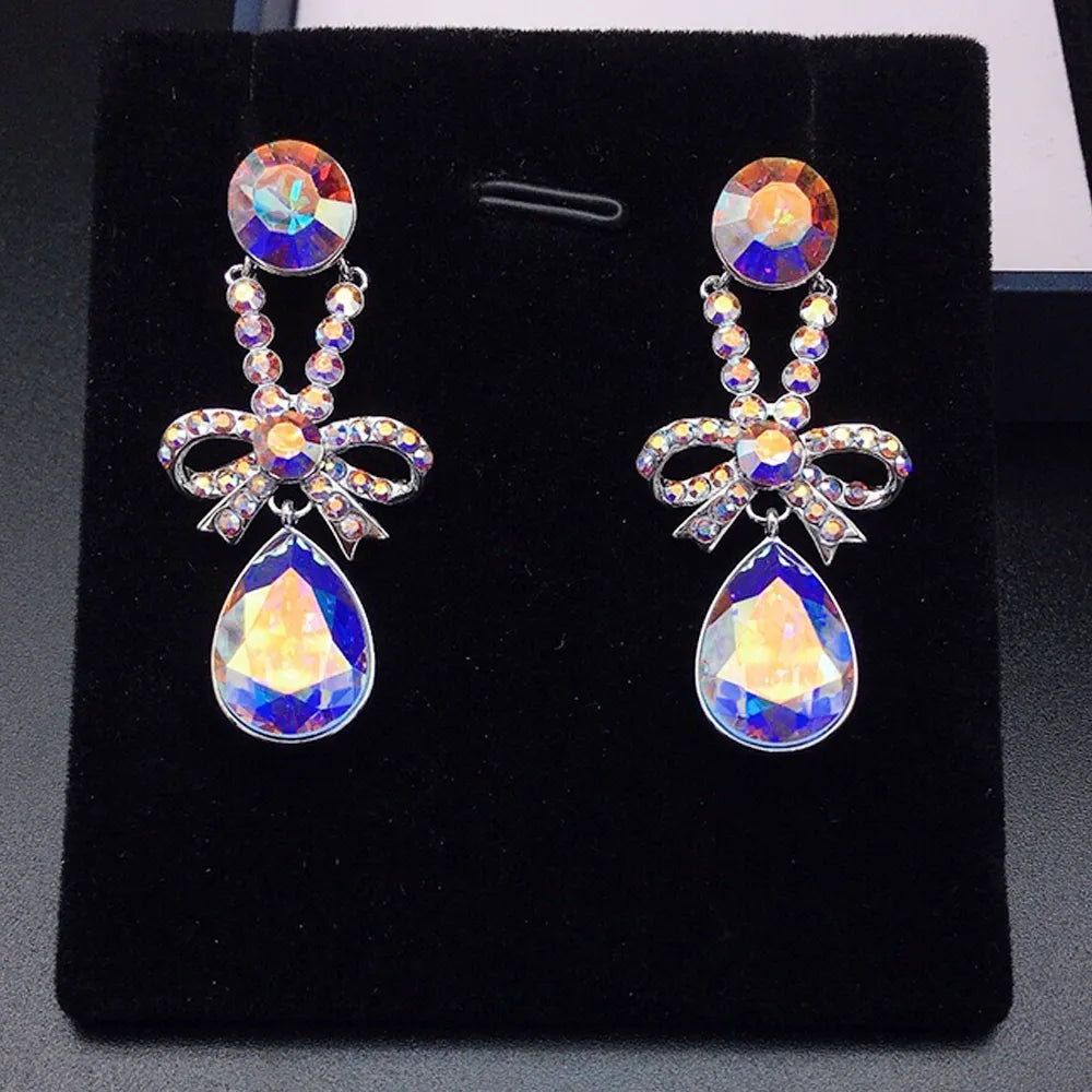 Boucles d'oreilles pendantes élégantes avec nœud en cristal violet pour femmes