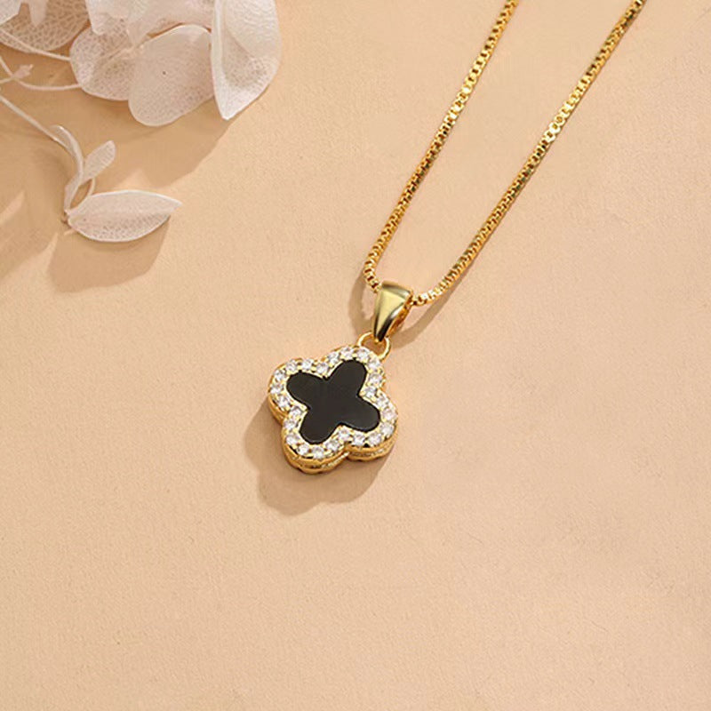 Black and white four-leaf clover necklace